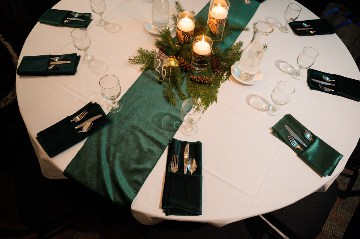 Winter wedding centerpiece and green table settings