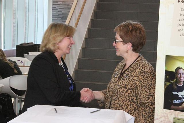 North Hennepin President Barbara McDonald, left, and SMSU President Dr. Connie Gores