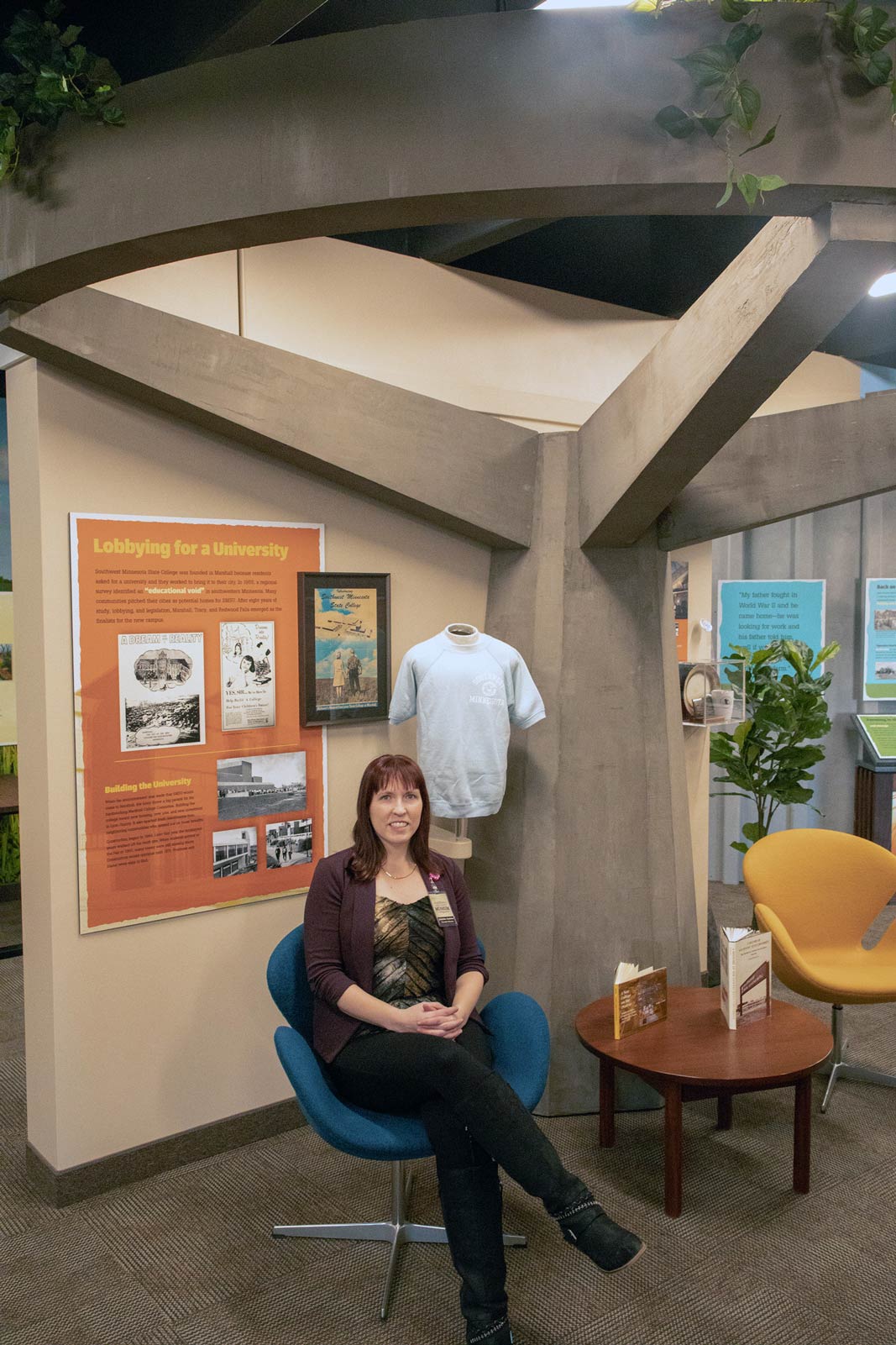 Jennifer Andries, sitting in the new SMSU display on the second floor of the Lyon County Historical Museum