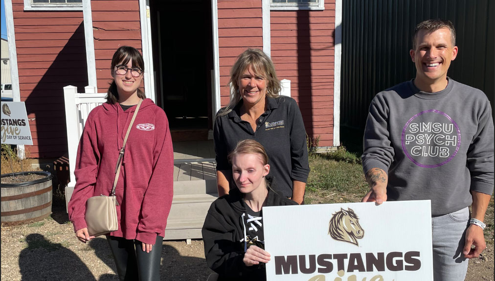 Matthew Maloney, pictured on the right, with his volunteer team on Mustangs Give: Day of Service.