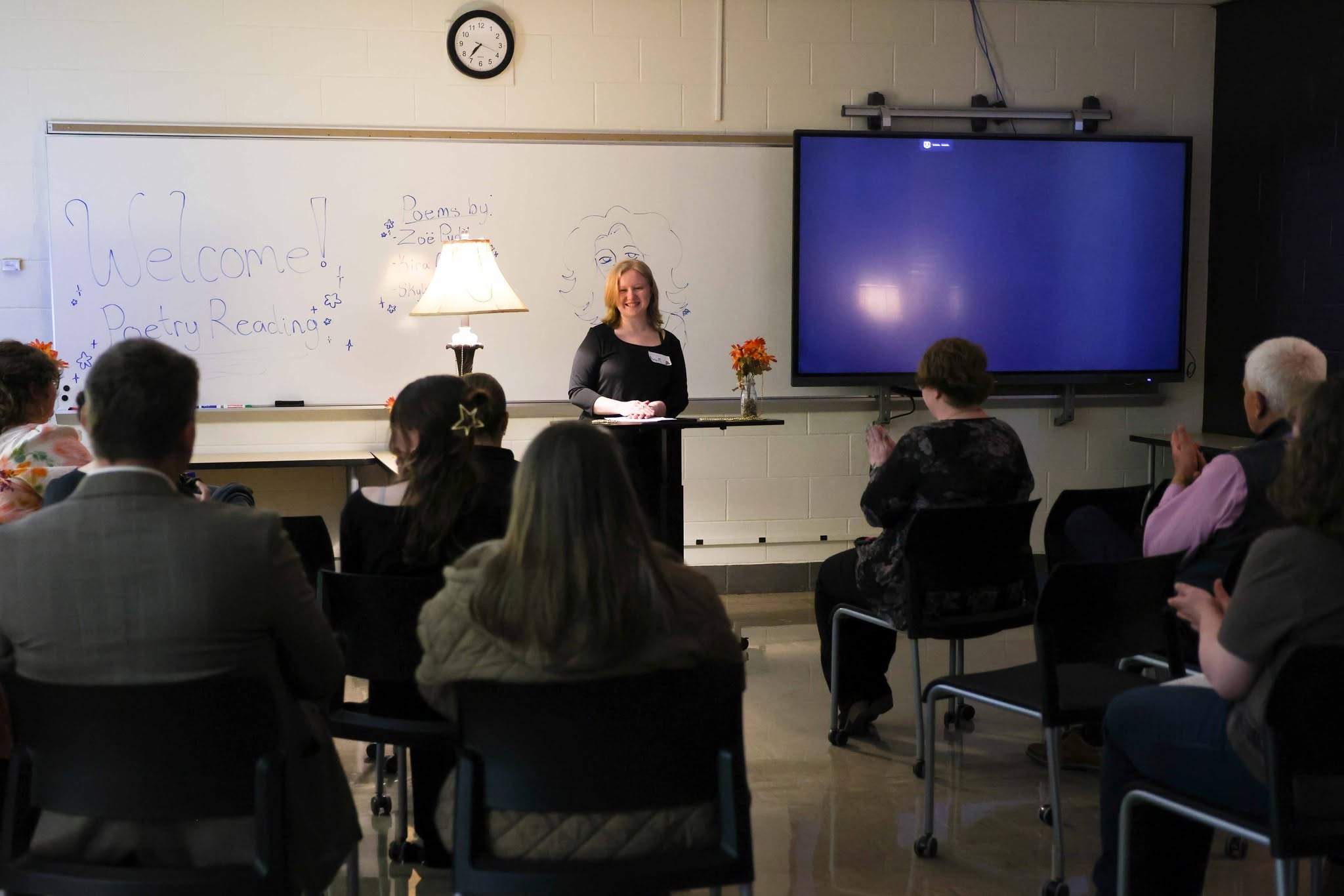 Creative Writing student reading a written piece to attendees