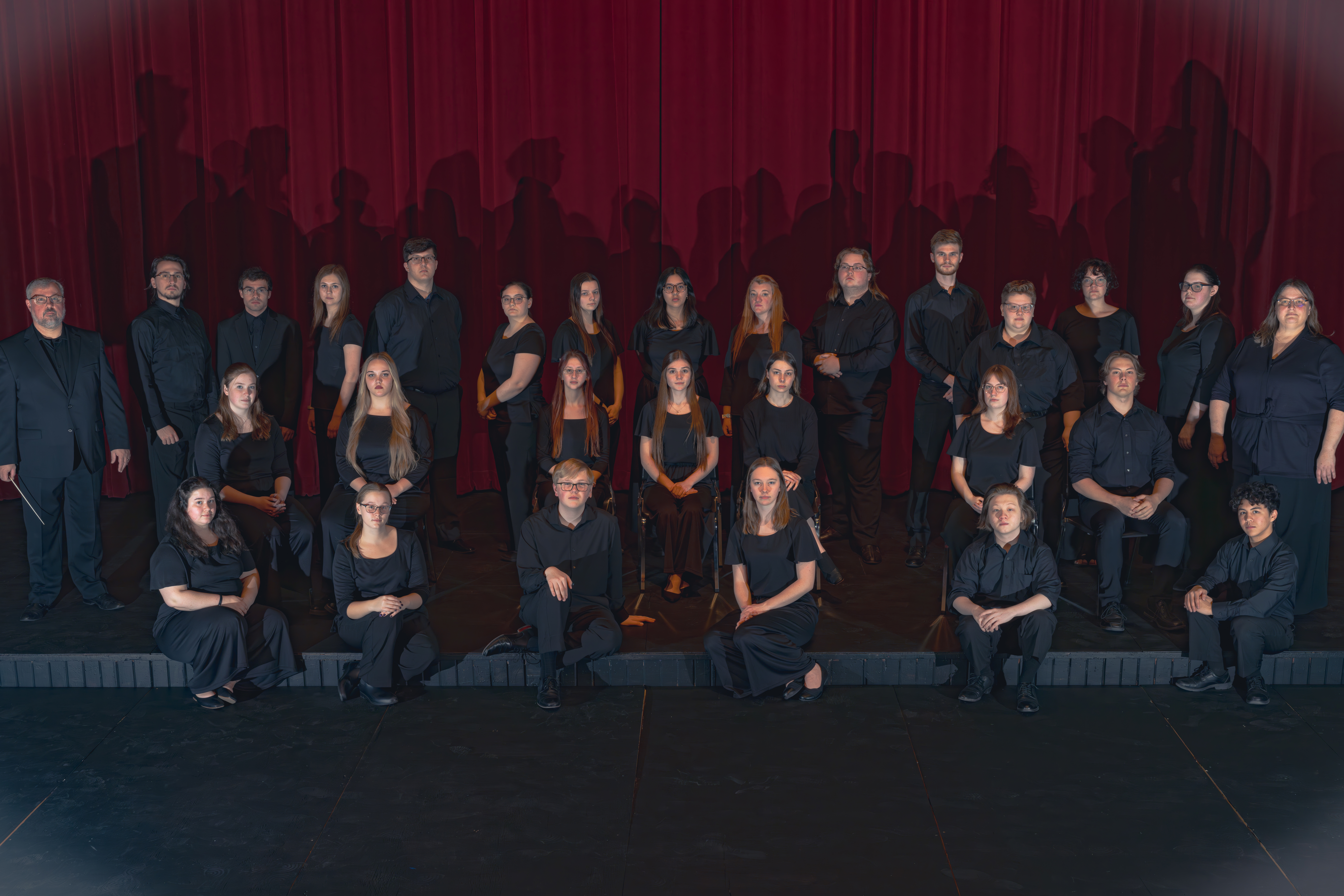 A picture of the 2023 Chorale posing on stage in the SMSU Fine Arts Threatre.