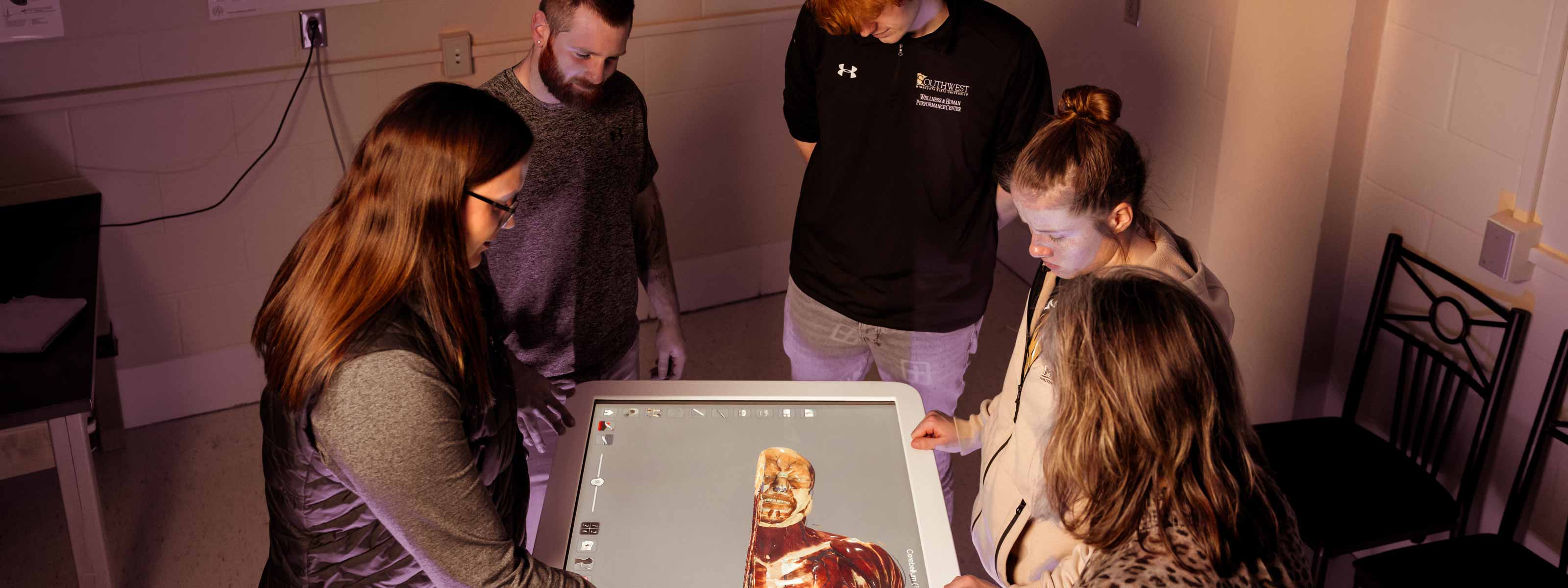Students around a virtual cadaver table