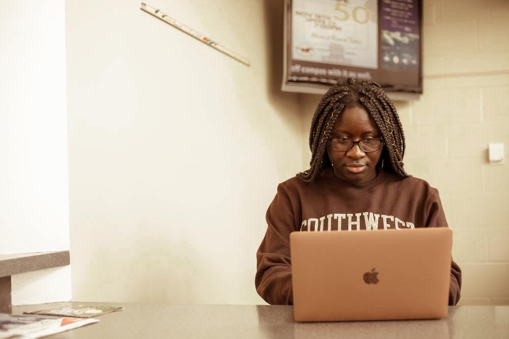 Student visiting virtually on a laptop