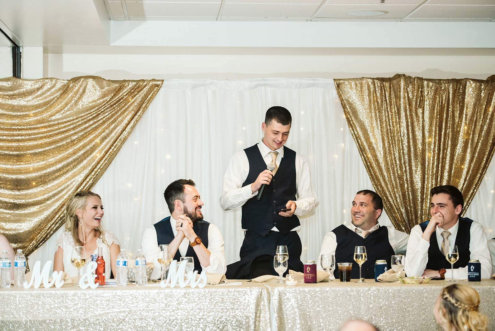 head table set up with gold drapery