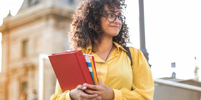 Woman holding notebooks