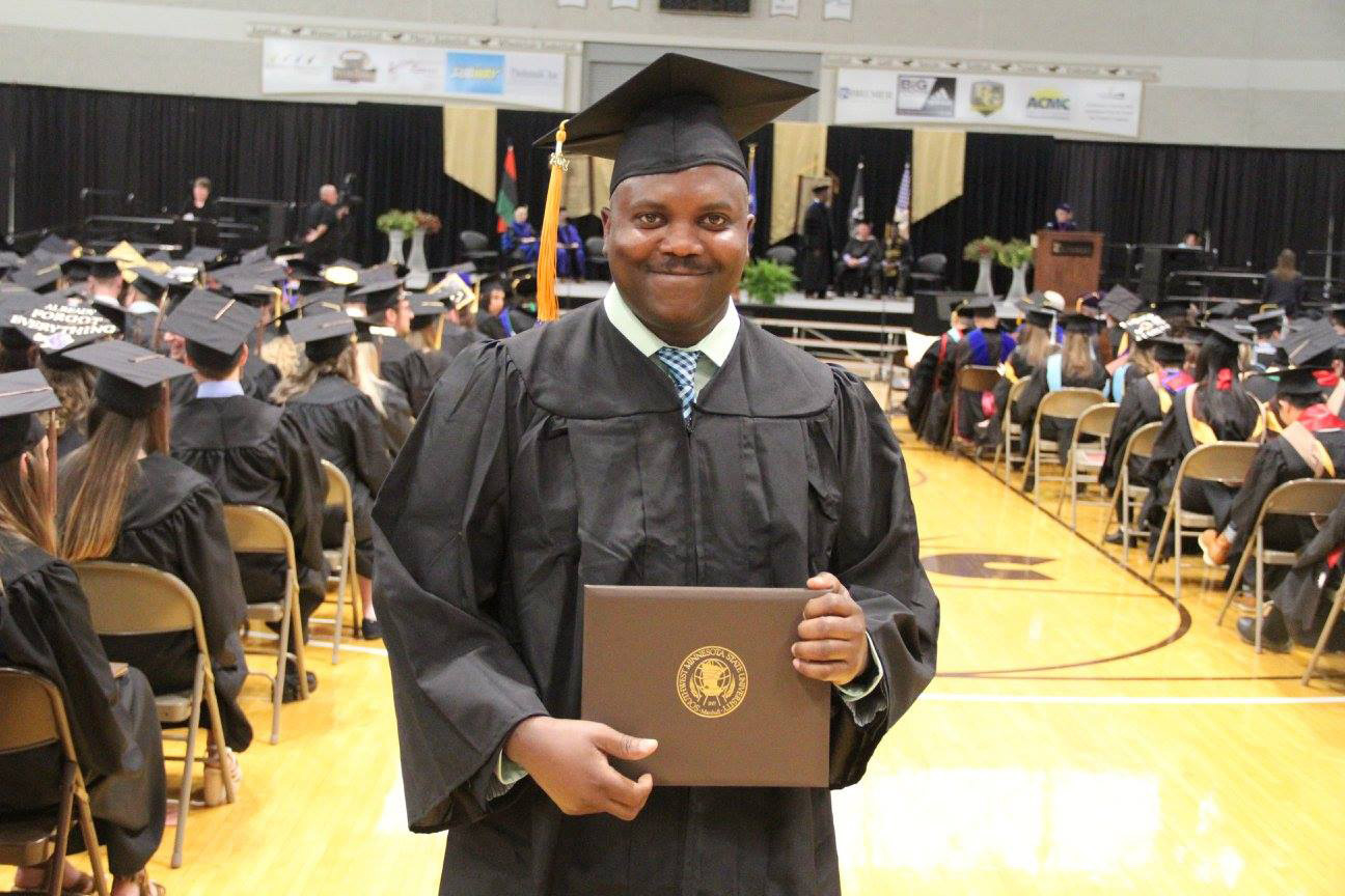 student holding certificate 