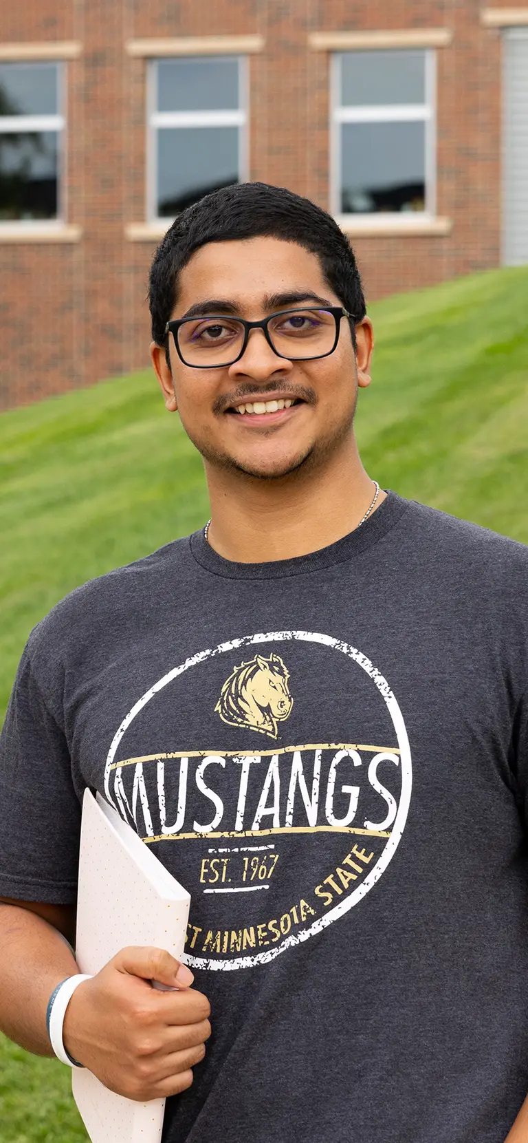 international student in front of the bellows academic building