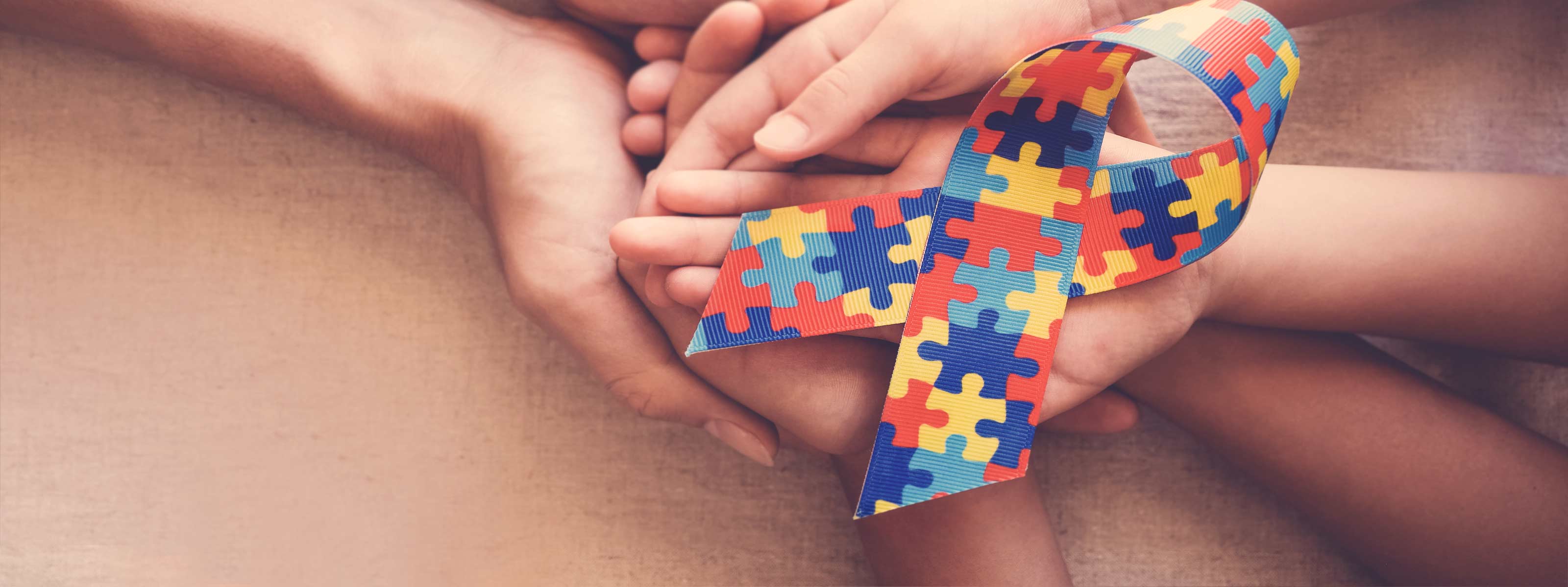 Hands holding Autism Awareness ribbon