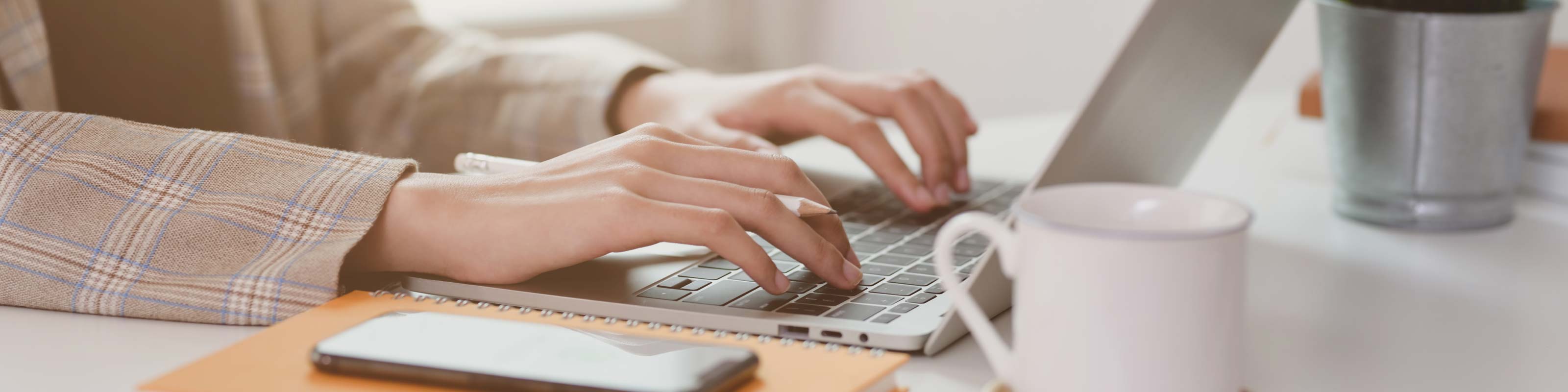 Typing on a laptop