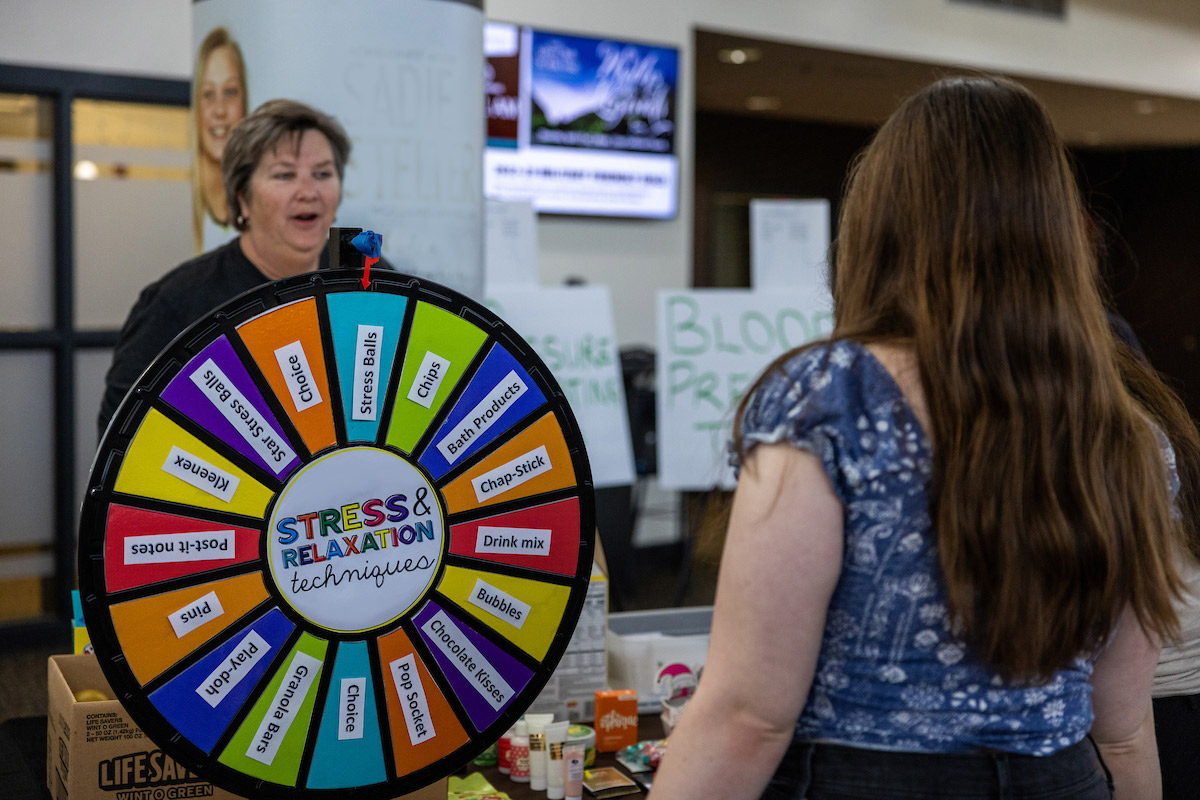 Diane Stieper, left, talks to a student at a recent Health & Wellness Fair