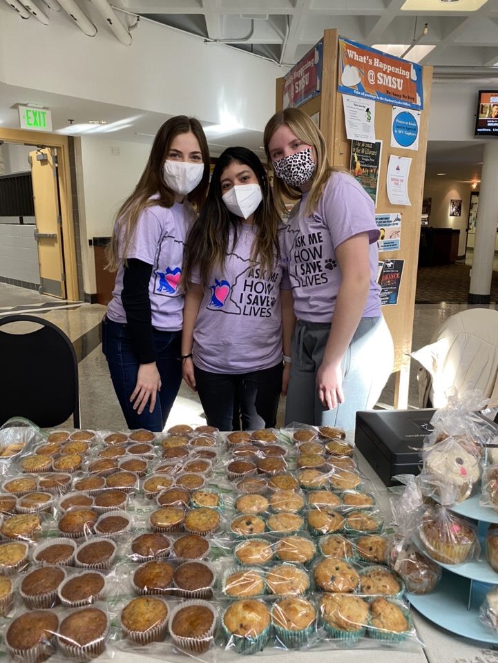 From Left: Students Sarah Strandemo, Dalano, Minn.; Ana Rugama, Nicaragua; and Hannah Penske, Wood Lake, Minn., working the recent bake sale that raised $650 for Enactus