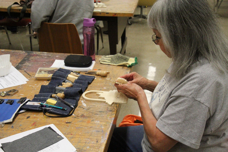 A student in a wood carving class offered through GOLD College.