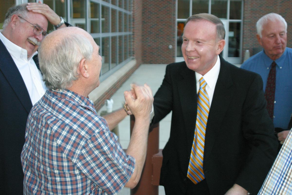 Jon Wefald greets Ed Carberry in 2007, with Jack Hickerson at left, and Bob Aufenthie at back, right.
