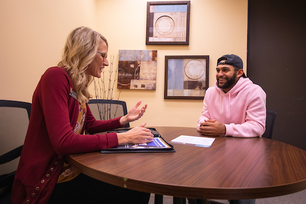 Brittany Krull, left, talks with a student in the newly-named Deeann Griebel Student Success Center